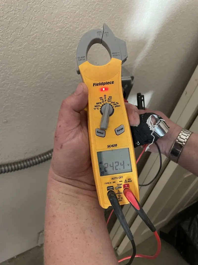 Voltage testing with clamp meter during Outlet Installation in De Pere